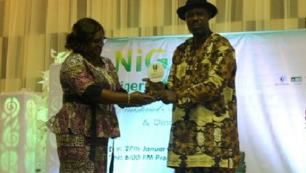 Basil Agboarumi, general manager, Corporate Communications (l), receiving NIGAV award from Mrs Anastasia Gbem, Legal Adviser, NAMA).